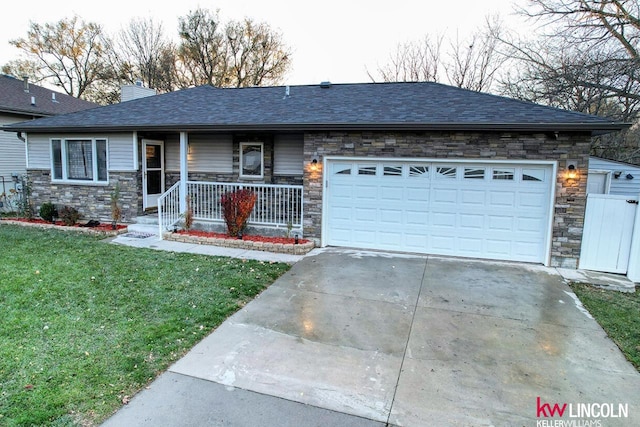 single story home with a front lawn, a porch, and a garage