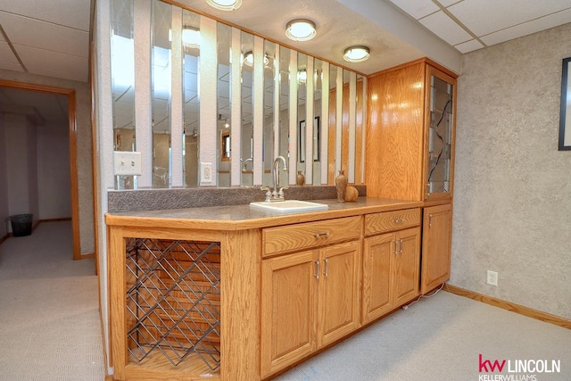 bathroom with a drop ceiling and sink