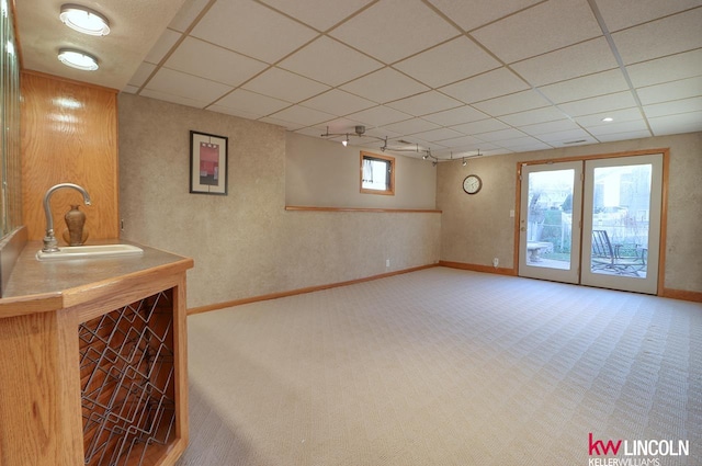 interior space with carpet flooring, a wealth of natural light, and a drop ceiling