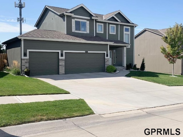 view of front of home with a garage and a front lawn