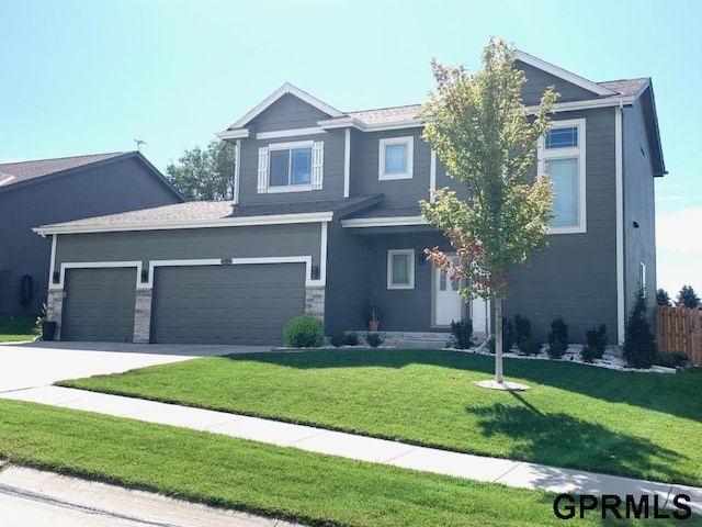 view of front of house featuring a front yard and a garage