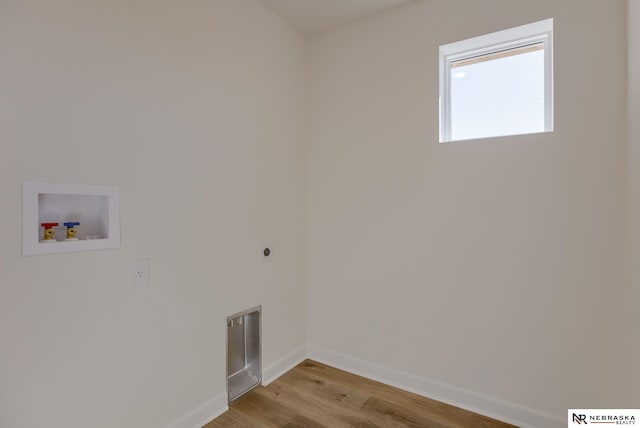 washroom featuring washer hookup, light hardwood / wood-style flooring, and electric dryer hookup