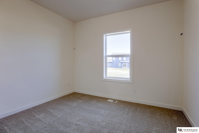 carpeted empty room with baseboards and visible vents