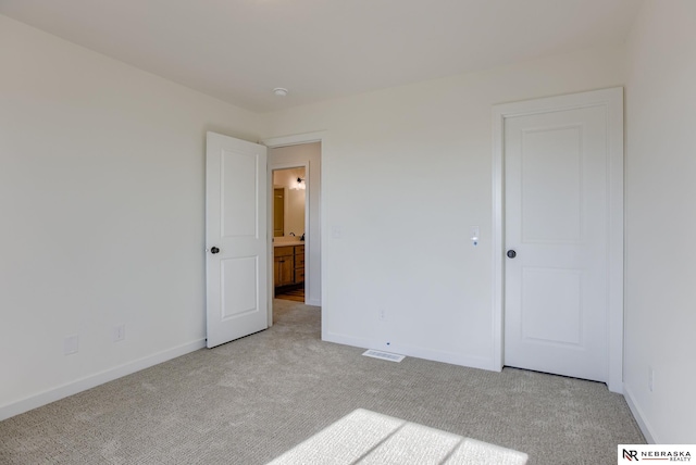 unfurnished bedroom with carpet and baseboards