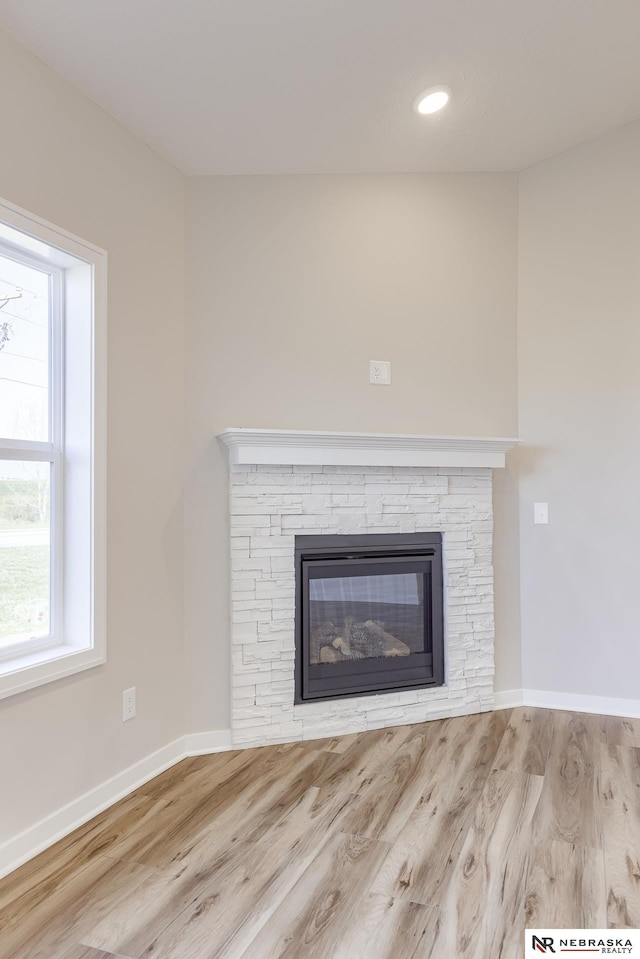 room details with hardwood / wood-style flooring and a fireplace