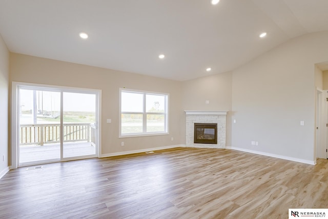 unfurnished living room featuring lofted ceiling and light hardwood / wood-style flooring