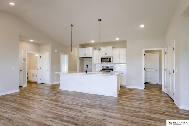 kitchen with white cabinetry, sink, an island with sink, and appliances with stainless steel finishes