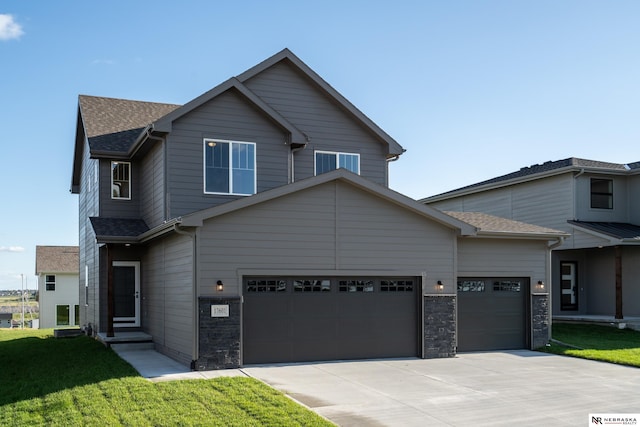 view of front of home with a front lawn and a garage