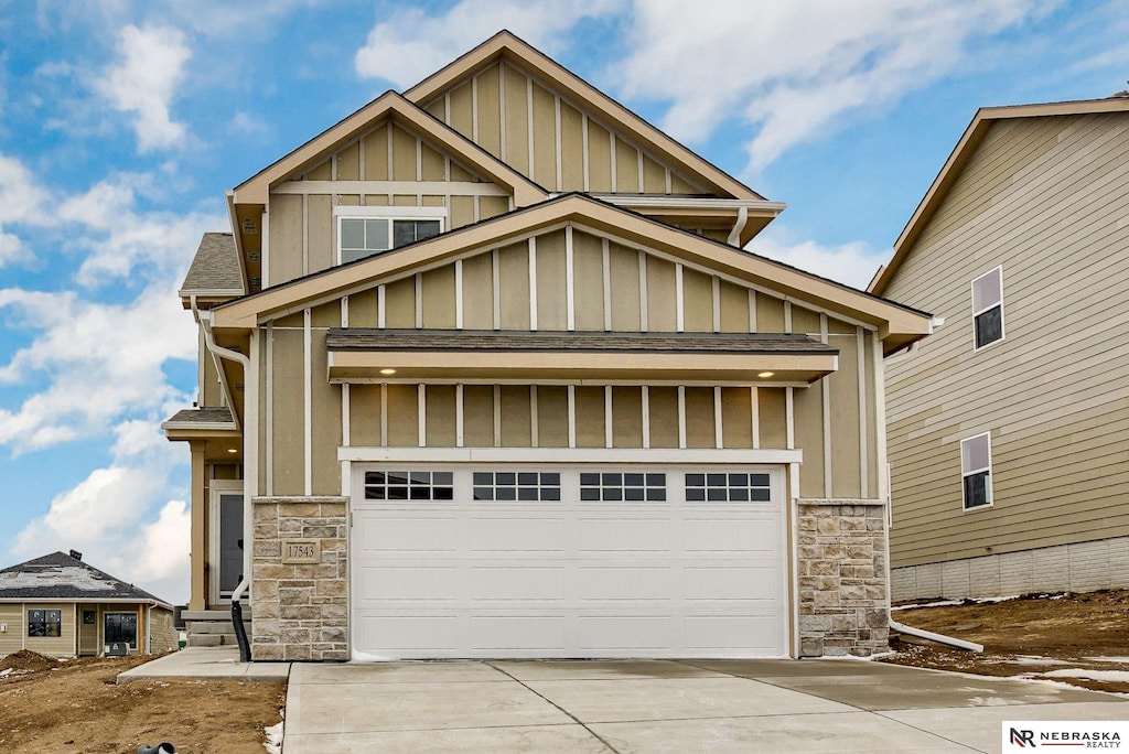17543 Potter St, Bennington, NE 68007 - craftsman-style house with board and batten siding, stone siding, and concrete driveway