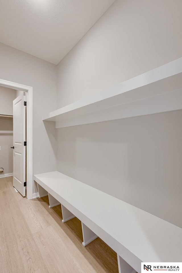 mudroom with baseboards and light wood finished floors