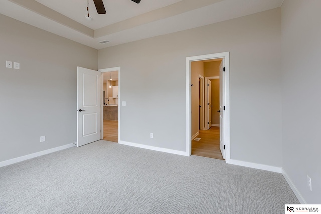 unfurnished bedroom with baseboards, visible vents, and light colored carpet