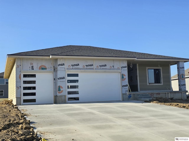 property under construction with concrete driveway and an attached garage