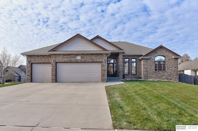 view of front of property with a garage and a front lawn