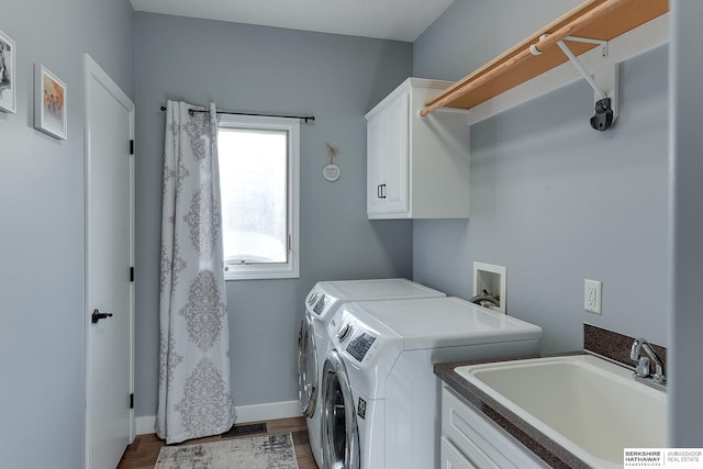 washroom with hardwood / wood-style floors, sink, cabinets, and independent washer and dryer