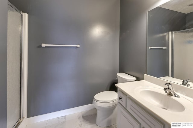 bathroom with vanity, an enclosed shower, and toilet