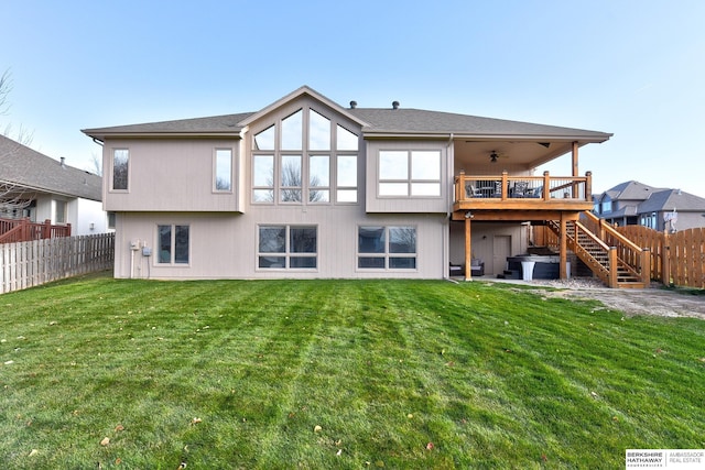 rear view of house featuring a lawn, ceiling fan, and a deck