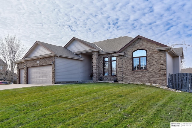 view of front of house featuring a front yard and a garage