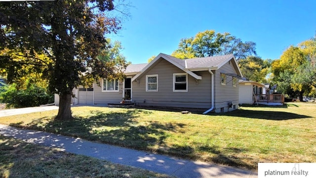 view of front of property with a front yard and a garage