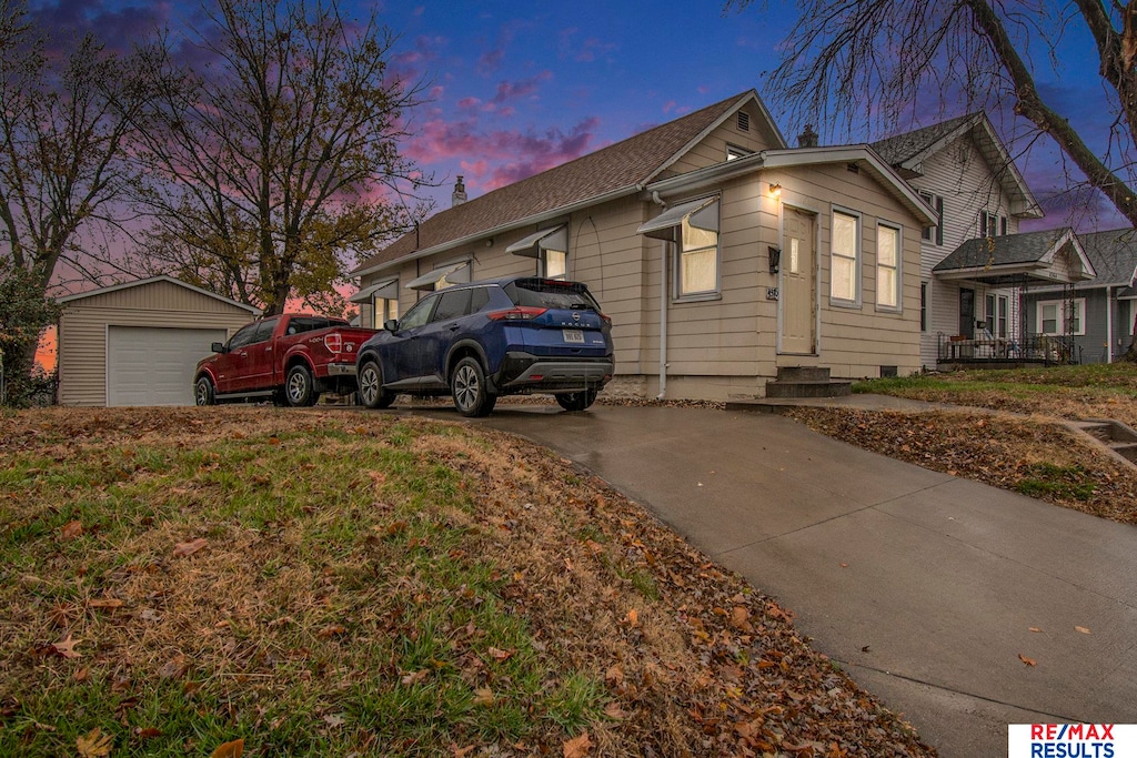 view of front facade featuring a garage and an outdoor structure