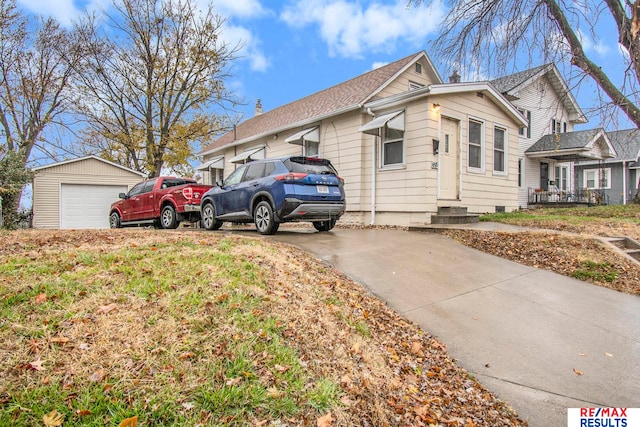 view of front of home featuring a garage and an outdoor structure