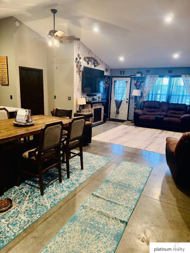 dining space featuring a stone fireplace