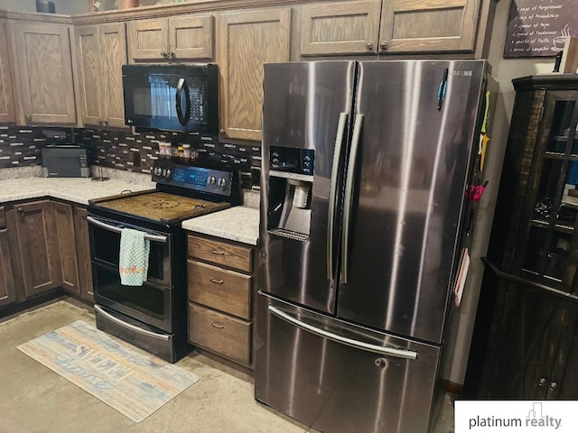 kitchen featuring tasteful backsplash, stainless steel appliances, and light stone countertops