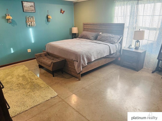 bedroom featuring concrete flooring