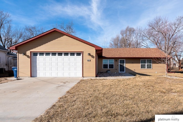 ranch-style home with a garage and a front lawn