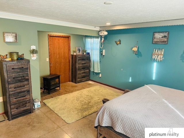 bedroom featuring ornamental molding, a textured ceiling, and a wood stove