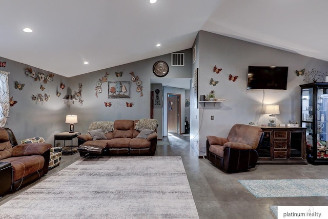 living room with vaulted ceiling and concrete floors