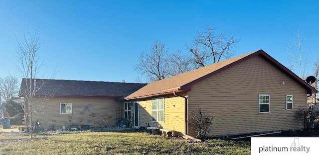 view of property exterior featuring a lawn