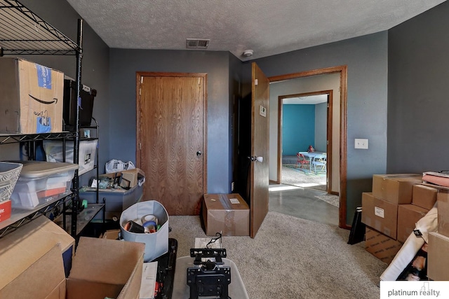 interior space with light colored carpet and a textured ceiling