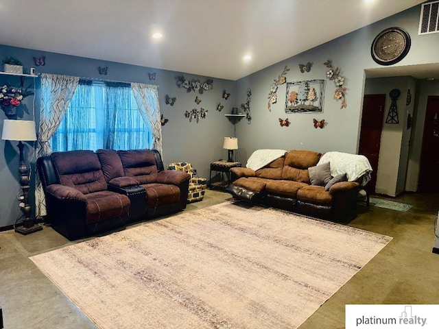 living room with vaulted ceiling and concrete floors