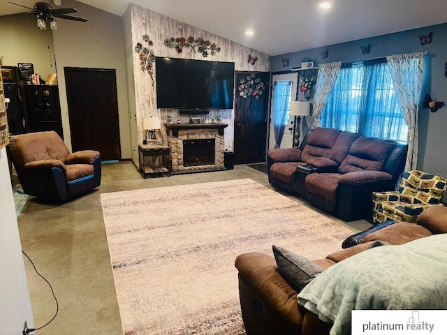 living room with ceiling fan, a fireplace, and concrete floors