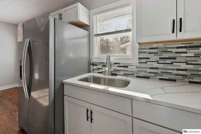 kitchen with white cabinetry, sink, tasteful backsplash, stainless steel fridge with ice dispenser, and dark hardwood / wood-style floors