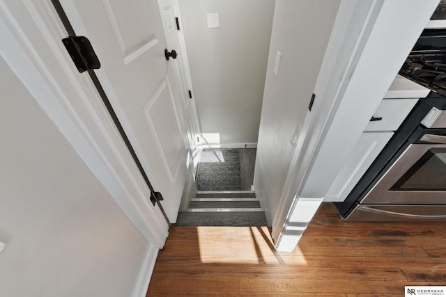 stairs featuring hardwood / wood-style floors