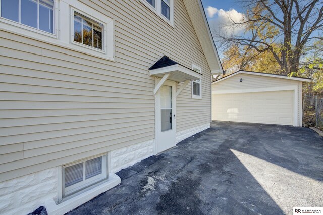 view of home's exterior featuring an outbuilding and a garage