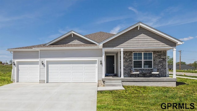 view of front of property featuring a garage and a front lawn