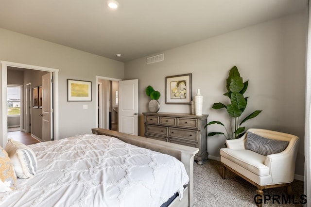 carpeted bedroom featuring connected bathroom