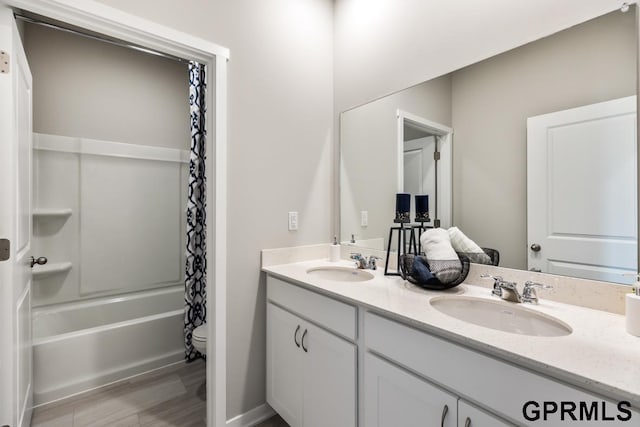 full bathroom with vanity, shower / bath combination with curtain, and toilet