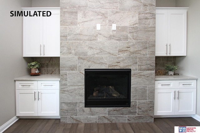 interior details with a fireplace, backsplash, and hardwood / wood-style flooring