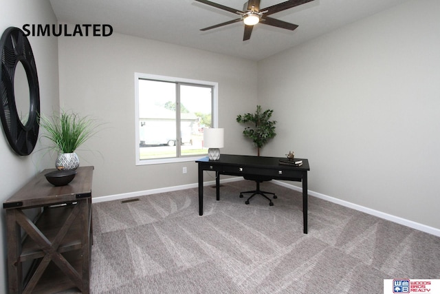 carpeted office space featuring ceiling fan