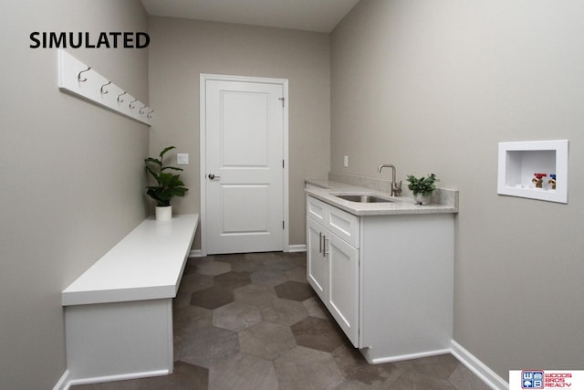 washroom featuring cabinets, sink, and hookup for a washing machine