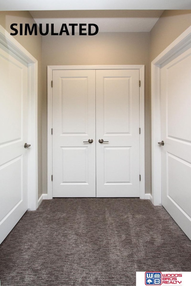 unfurnished bedroom featuring a closet and dark carpet