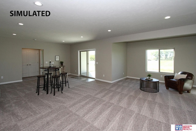 dining room with a healthy amount of sunlight and light colored carpet