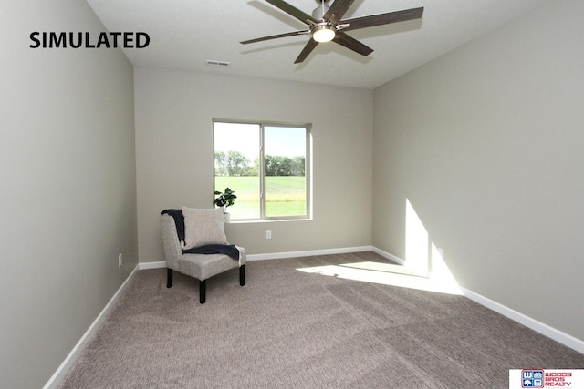 sitting room featuring ceiling fan and carpet