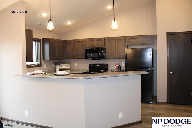 kitchen with hardwood / wood-style floors, black appliances, hanging light fixtures, vaulted ceiling, and kitchen peninsula