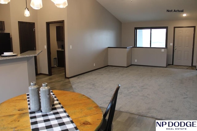 unfurnished dining area featuring carpet and lofted ceiling