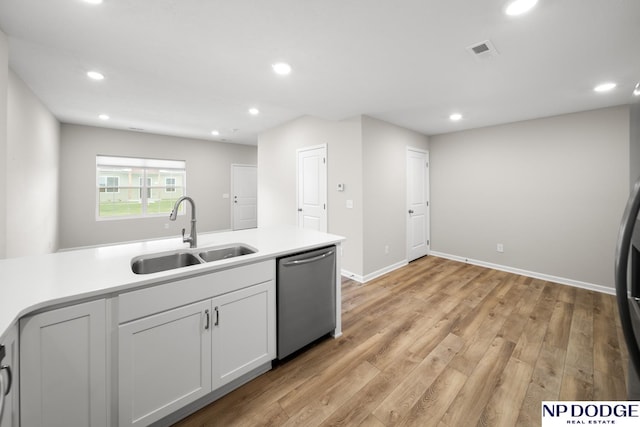 kitchen featuring white cabinets, dishwasher, light wood-type flooring, and sink