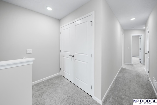 hallway with light colored carpet